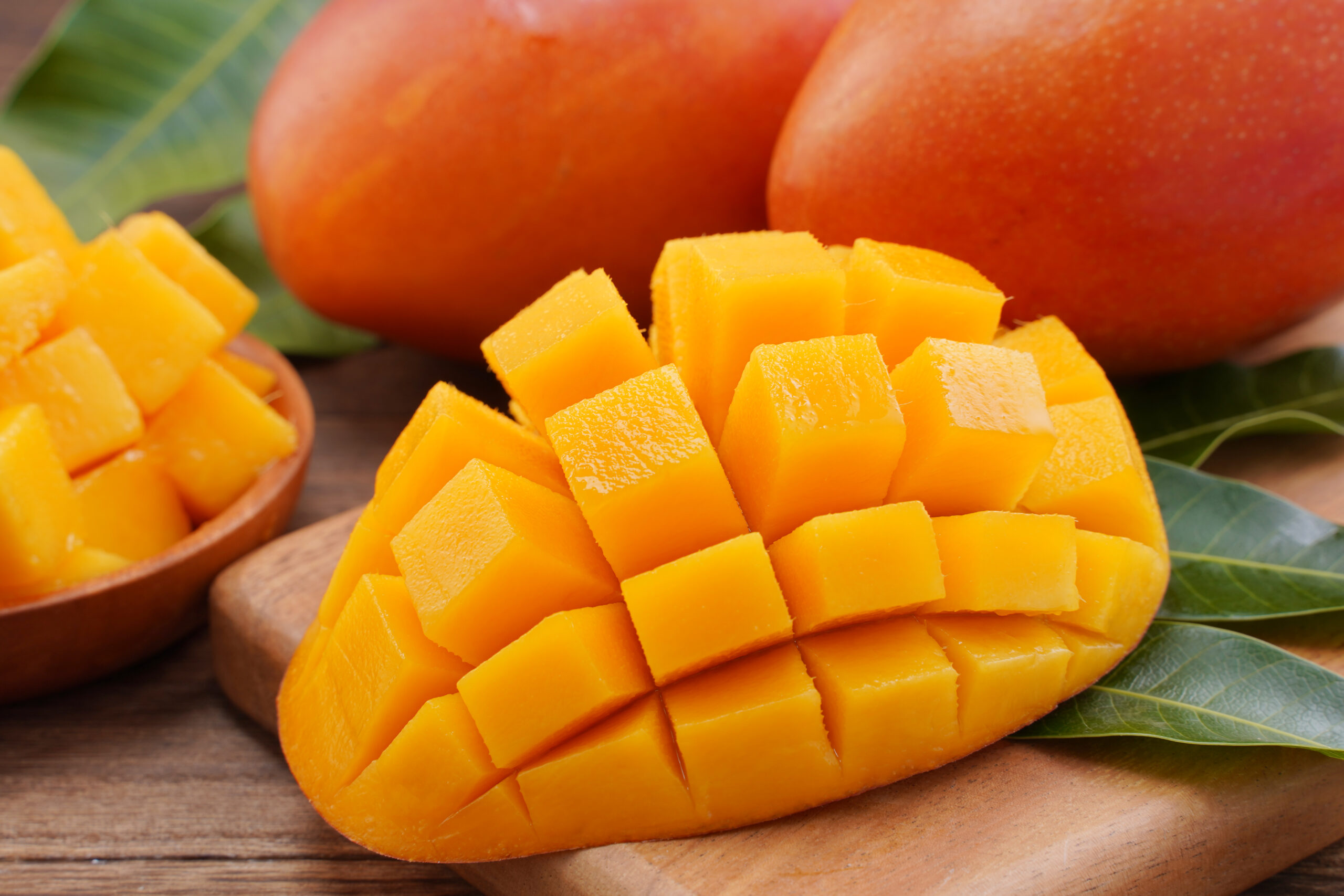 Close up fresh chopped mango with green leaves scaled